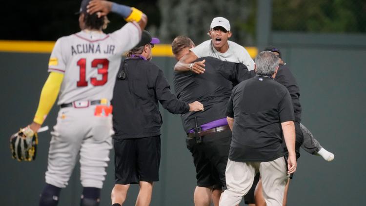 Ronald Acuña Jr. knocked over by fan charging field at Rockies game, but Braves star says he's OK