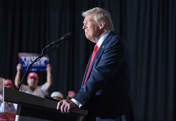 Donald Trump rails against migrants at Aurora rally, vowing to “hunt down”...